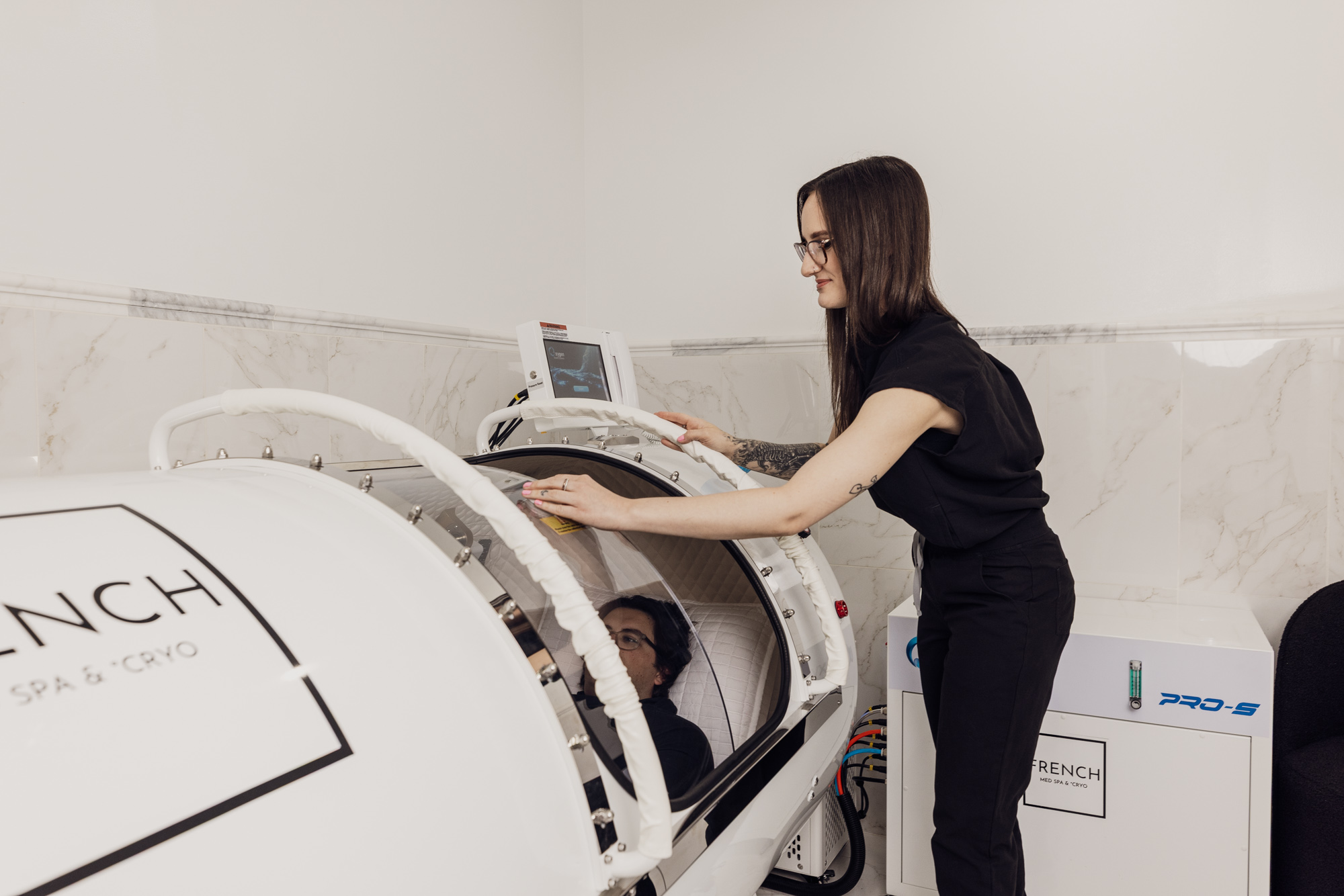 Hyperbaric oxygen chamber session with a client resting inside